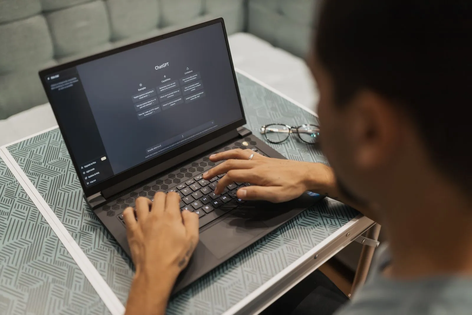 Laptop displaying an AI assistant interface for virtual assistant work