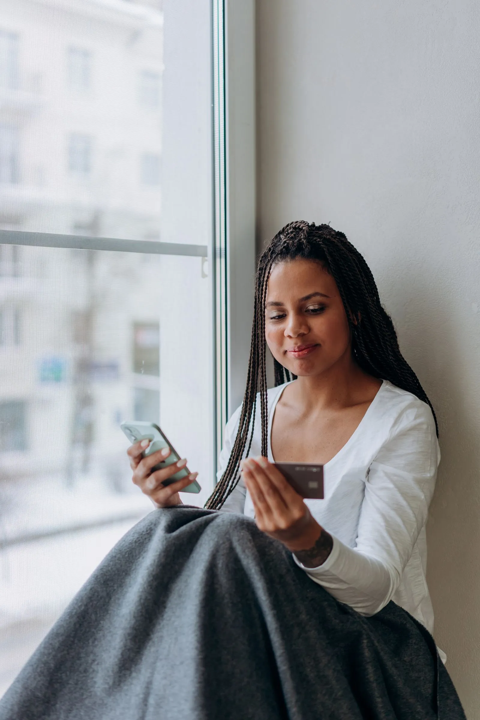 Freelancer using a smartphone and credit card for online payments