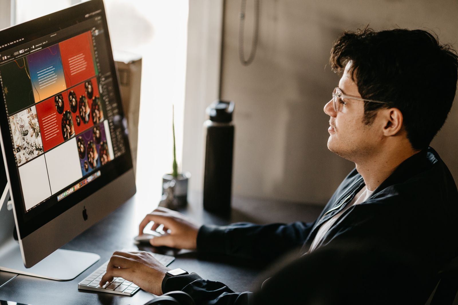 Digital content creator preparing social media graphics on a computer