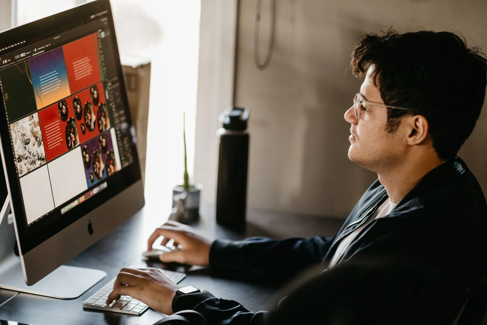 Digital content creator preparing social media graphics on a computer