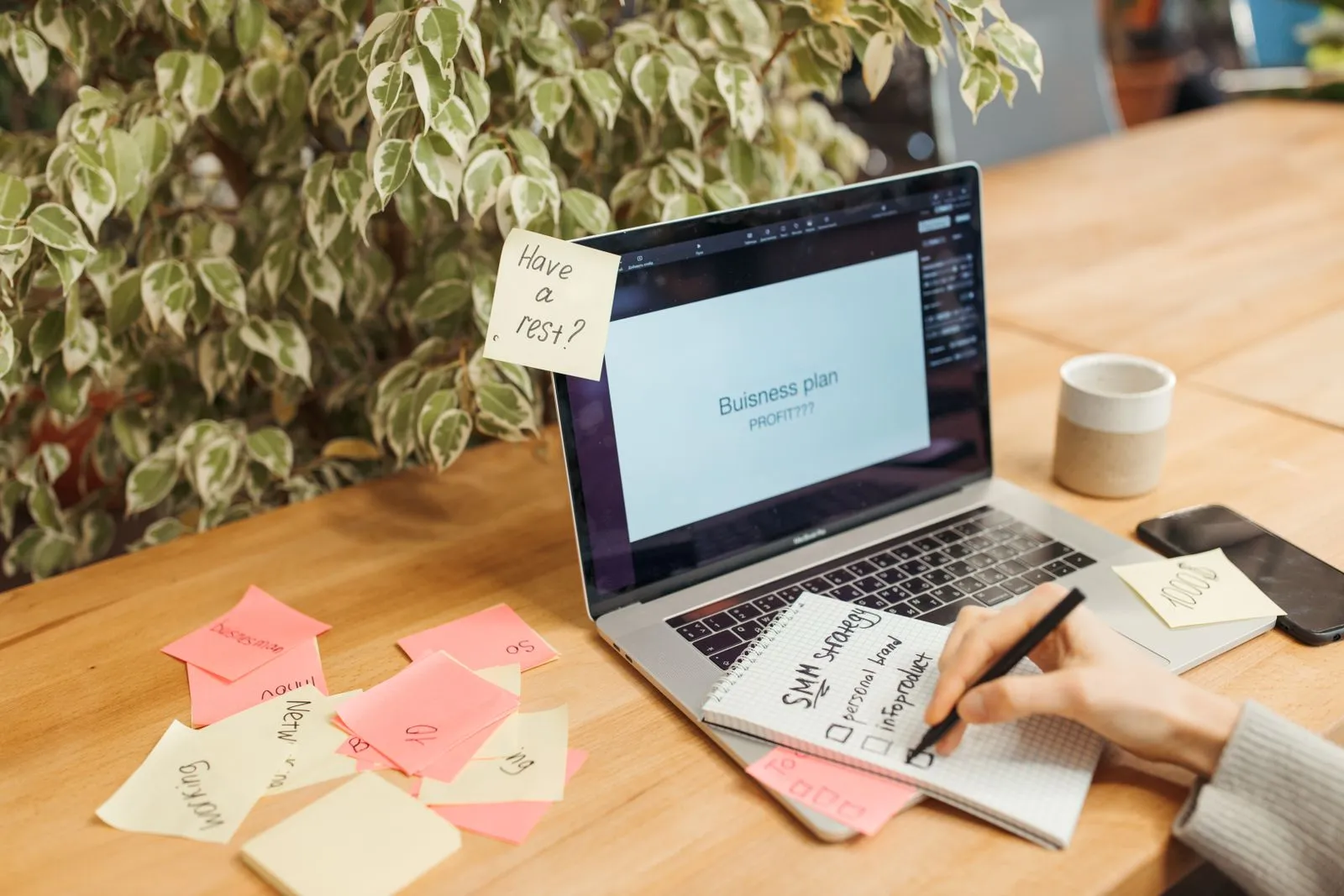 Laptop and sticky notes arranged for planning a client onboarding workflow