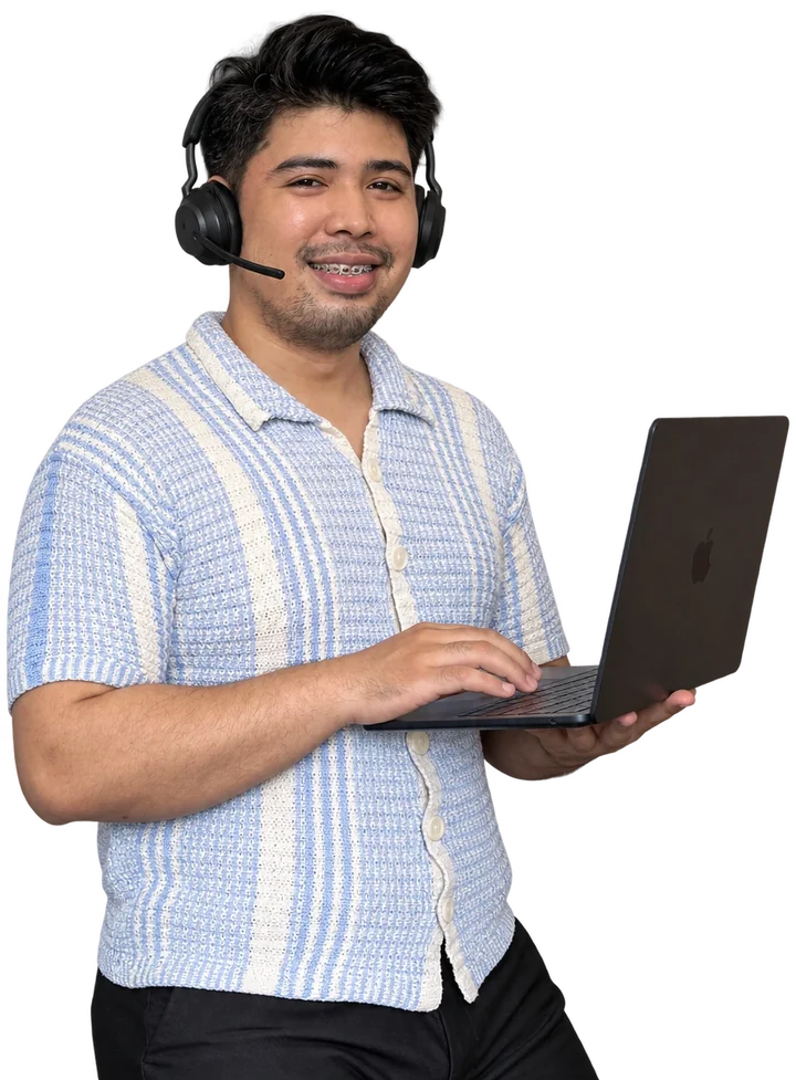 VA Starter Hub founder holding a laptop and wearing a headset, smiling